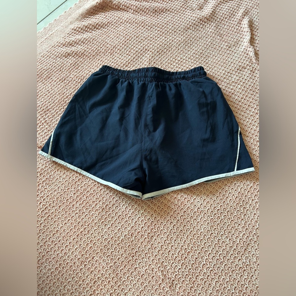 Navy and white shorts with drawstring waist.